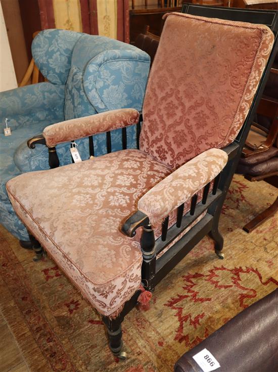 A late Victorian ebonised armchair